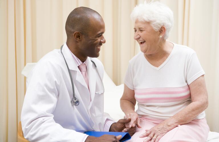 Doctor laughing with senior female patient