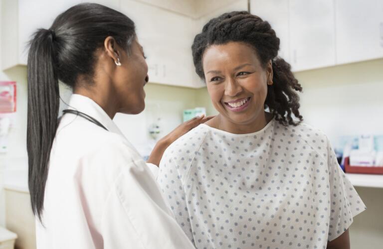 Doctor comforting patient in office