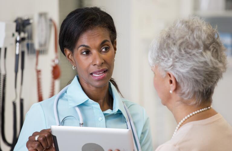 tech savvy doctor talking to patient