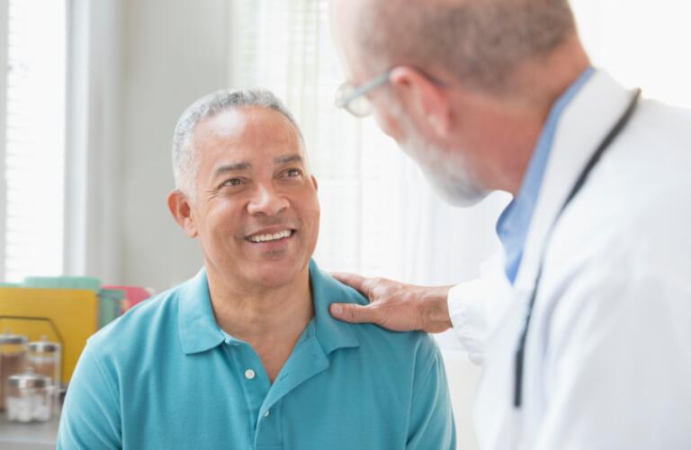 Doctor Talking to Man in Office