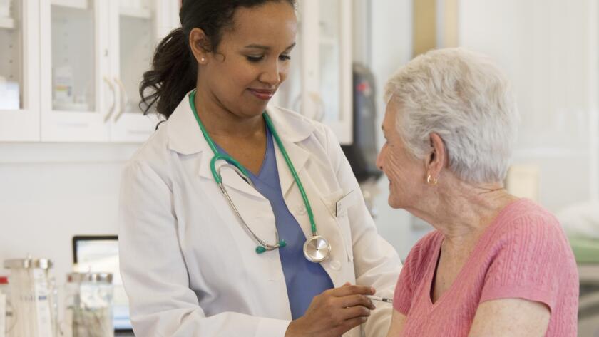 Doctor giving patient vaccination