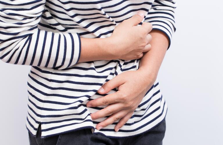 Woman holding stomach
