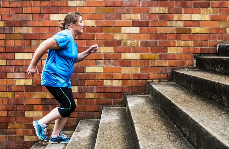 Woman jogging up stairs