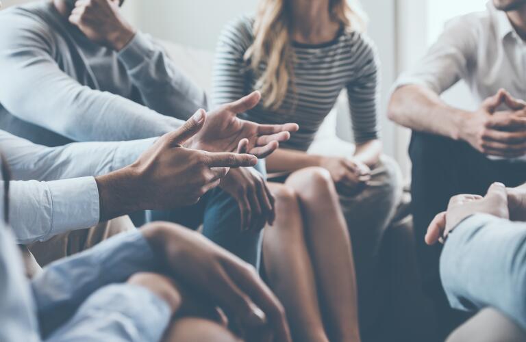 close up of support group discussion with hands
