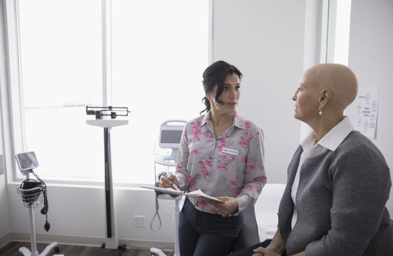 Female cancer patient with doctor in doctor's office