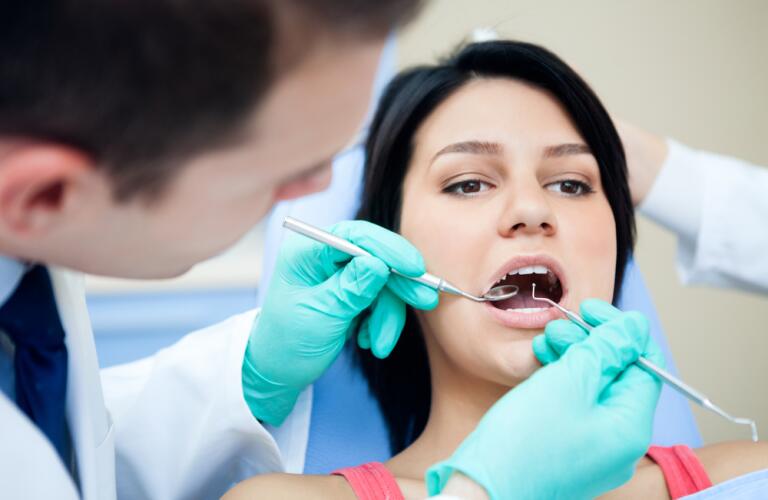 Dentist examining patients teeth