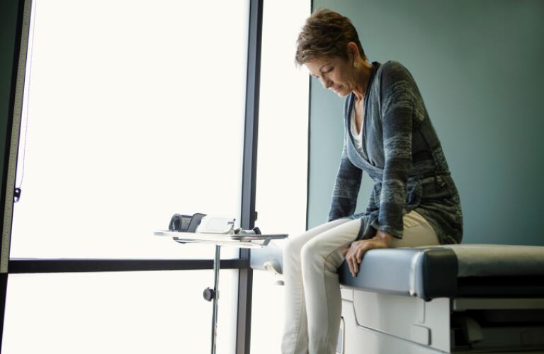 Senior woman sitting on hospital bed