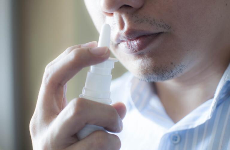 man using nasal spray