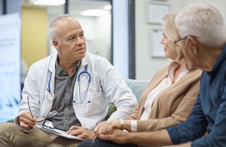 Professional doctor consulting senior couple
