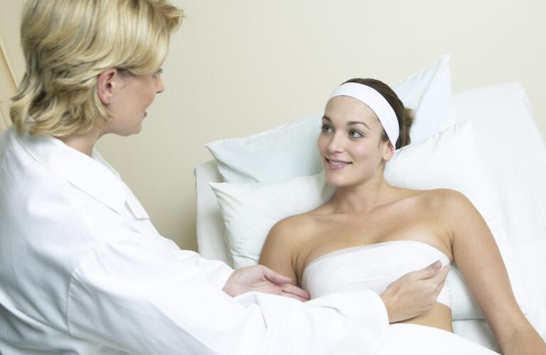Doctor examining bandaged woman