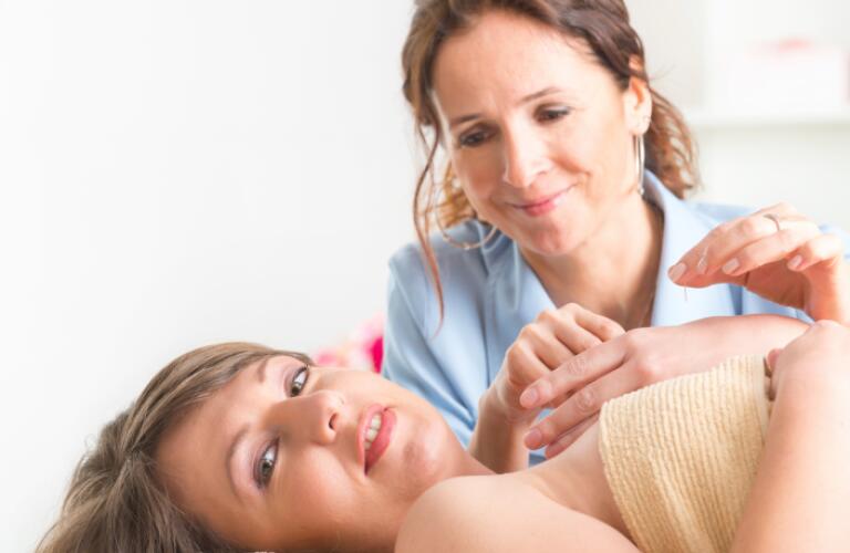 Acupuncture Therapist Applying Acupuncture Needle
