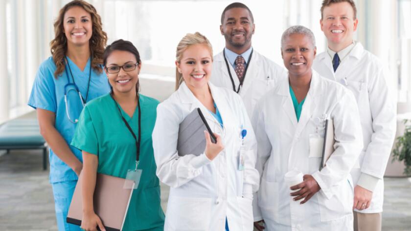 Large diverse group of hospital doctors, surgeons, and nurses