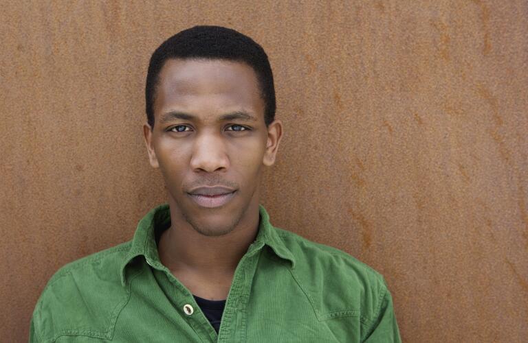 serious-man-leaning-against-wall