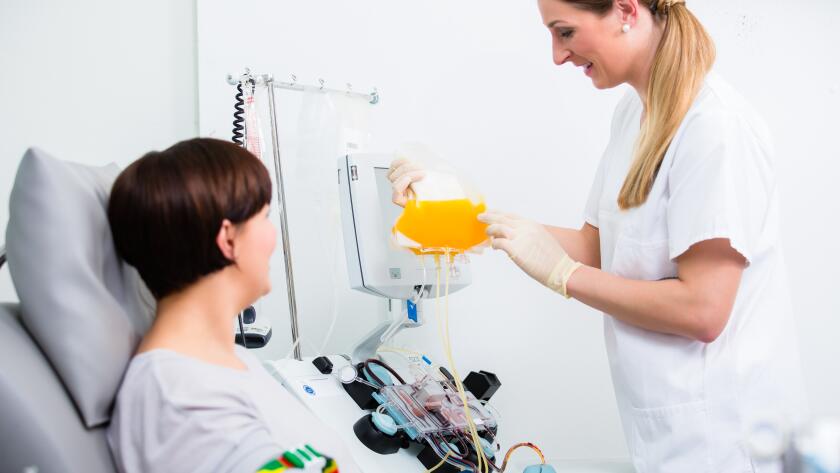 Nurse showing patient donating blood her own blood plasma