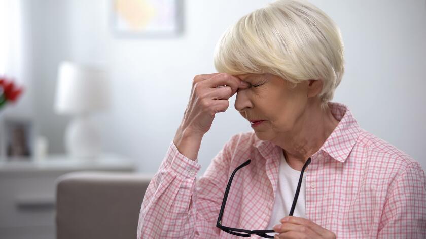 seniro Caucasian woman taking off eyeglasses and massaging bridge of nose