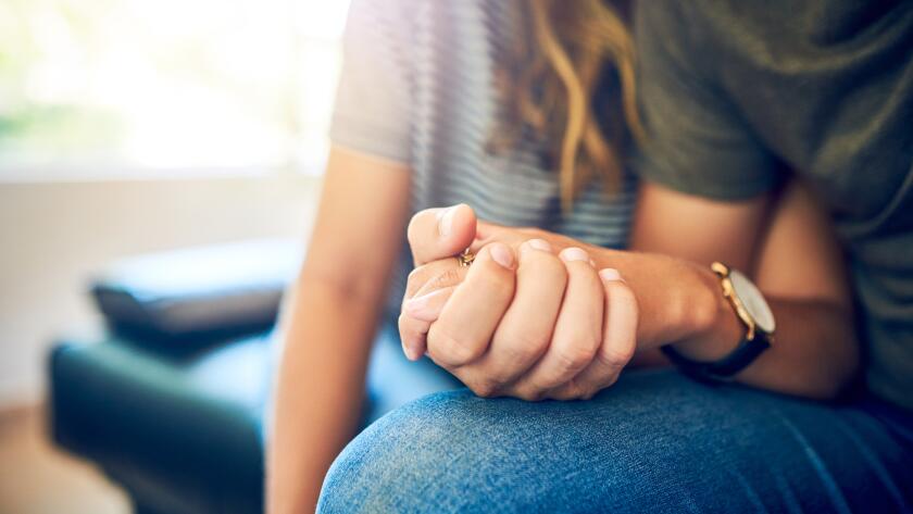 Close-up of Caucasian man and woman holding hands