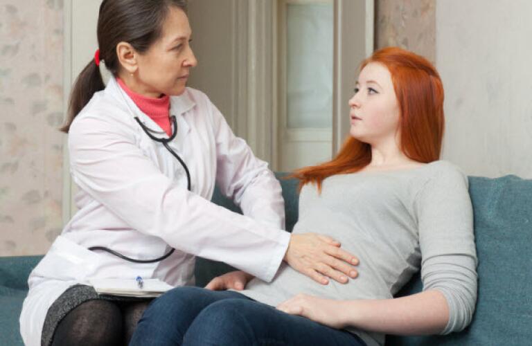 Doctor checking patient's stomach