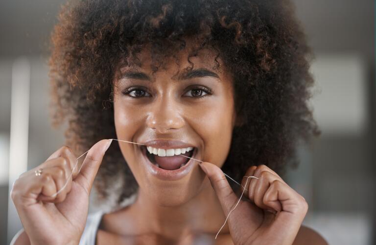 Woman flossing teeth