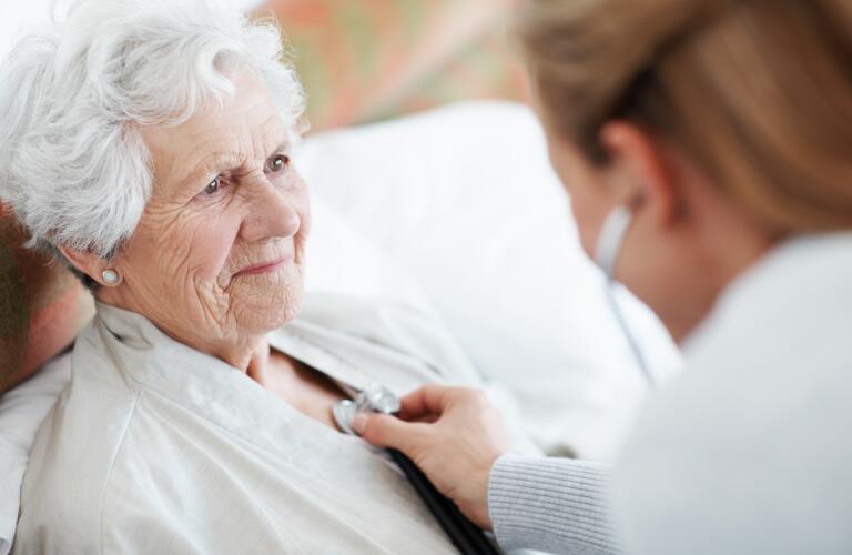 doctor examining elderly patient