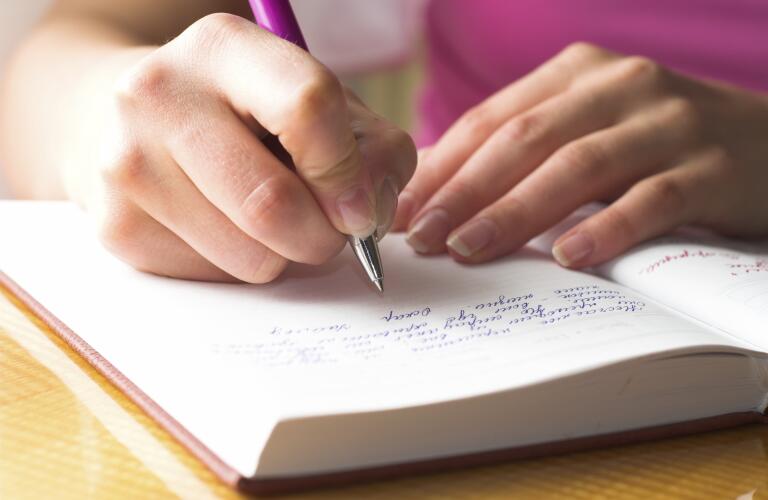 woman writing in journal