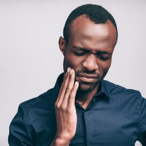african american man holding painful jaw