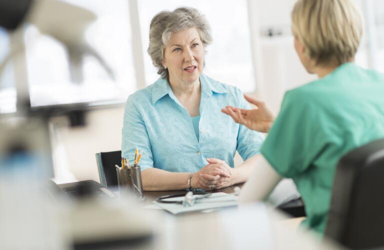 Doctor talking to patient in doctor's office