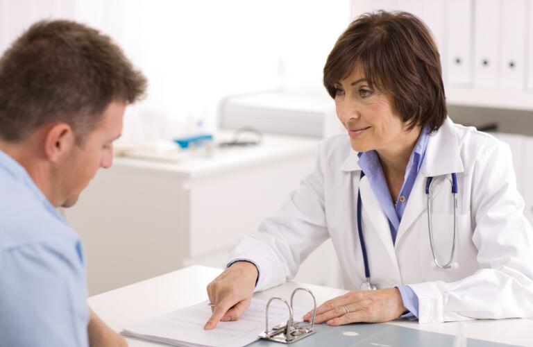 Female doctor with male patient looking at results