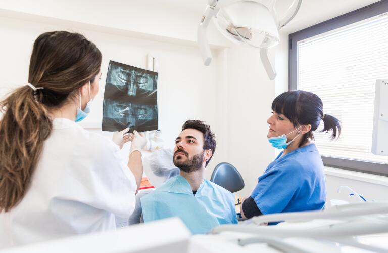 dentist showing x-rays to patient