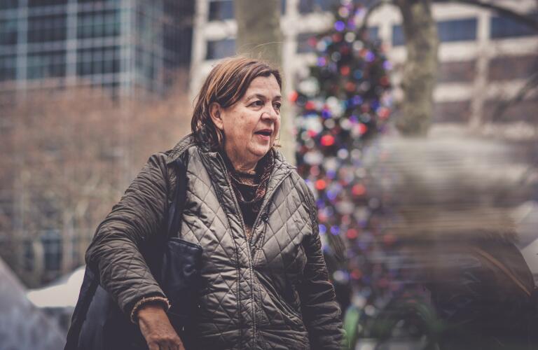 woman in city at Christmas time looking out at crowd