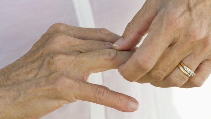 woman rubbing joints on hand