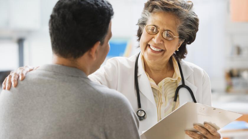 female doctor comforting male patient