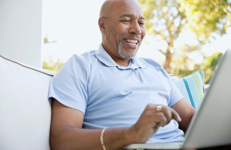 senior-man-on-laptop-outdoors