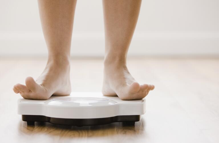woman-standing-on-weight-scale