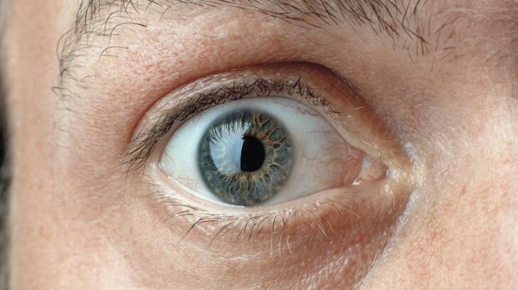 Close-up of Caucasian man's wide-open eye