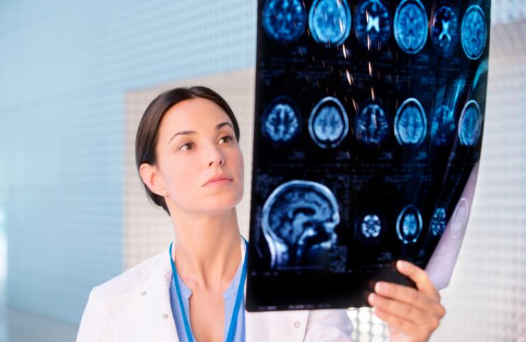 Serious doctor examining brain scan