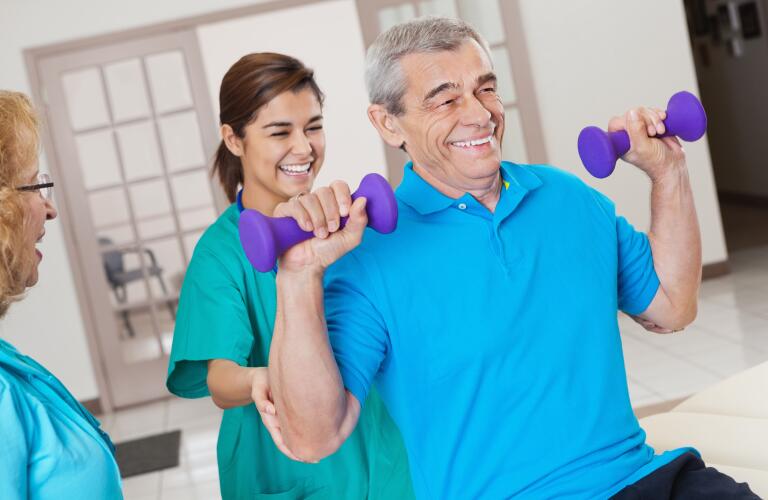 nurse-assisting-senior-patient-lifting-weights