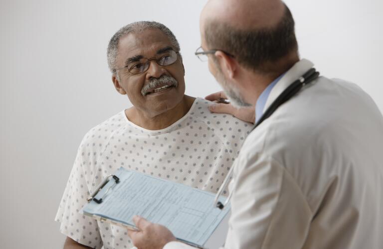 African man talking to doctor