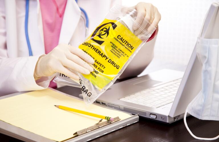 Doctor checking medication used by leukemia patient