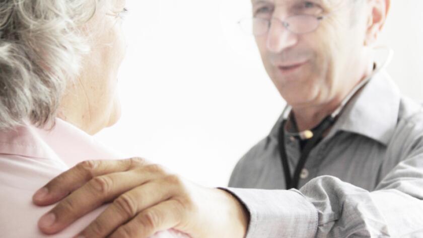 Doctor with hand on patients shoulder