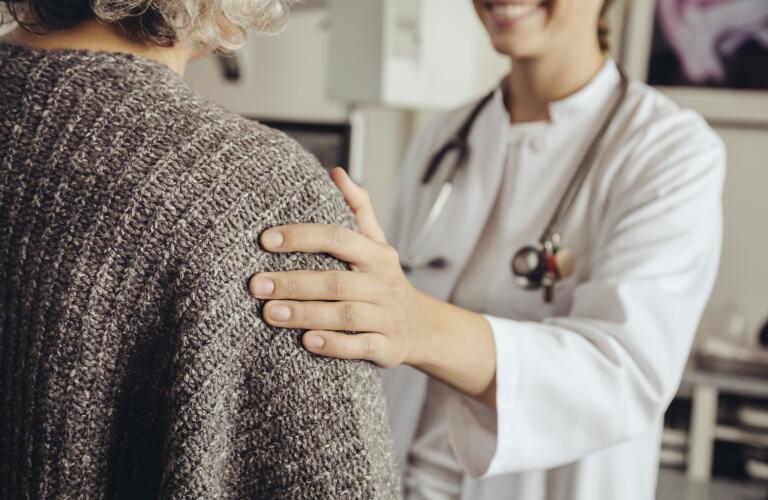 doctor with hand on patient's shoulder