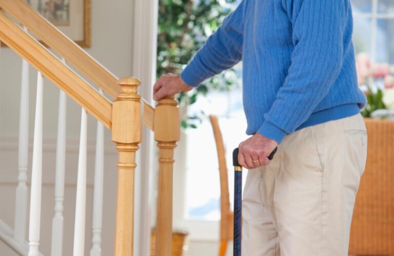 Man suffering from Parkinson's disease and multiple sclerosis standing near steps