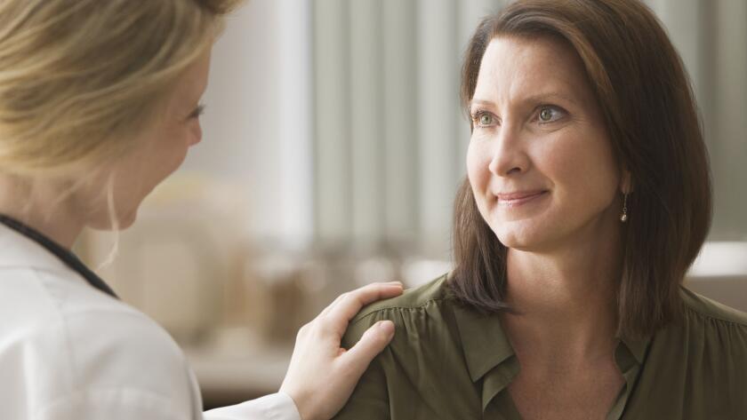 Female doctor talking with patient
