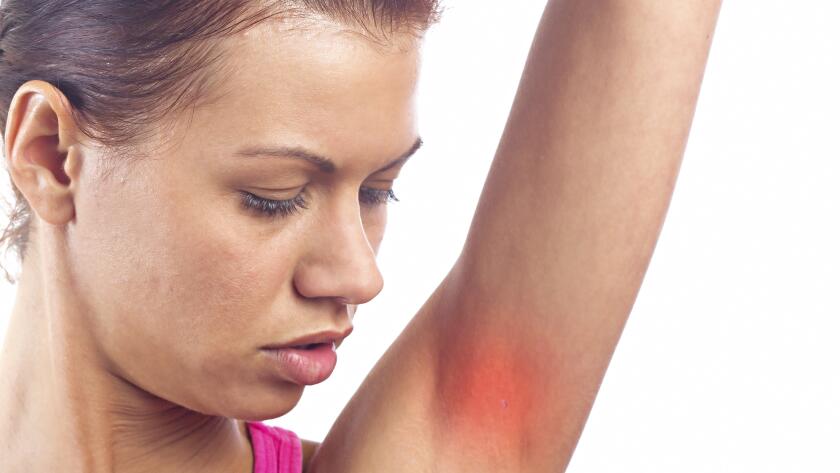 woman-looking-at-skin-condition