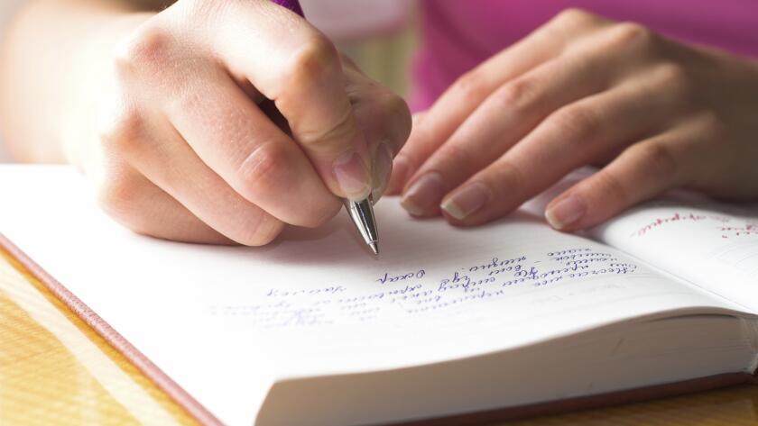 woman writing in journal