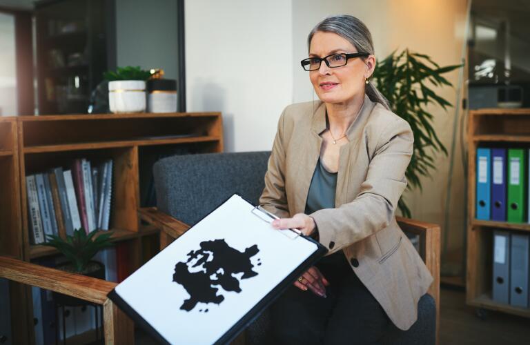 photo of a mature female psychologist conducting an inkblot test during a therapeutic session
