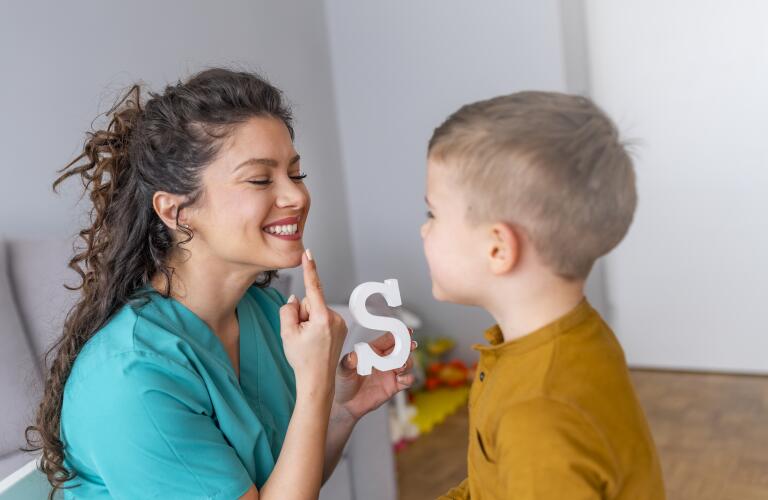 speech therapist during a session with a little boy