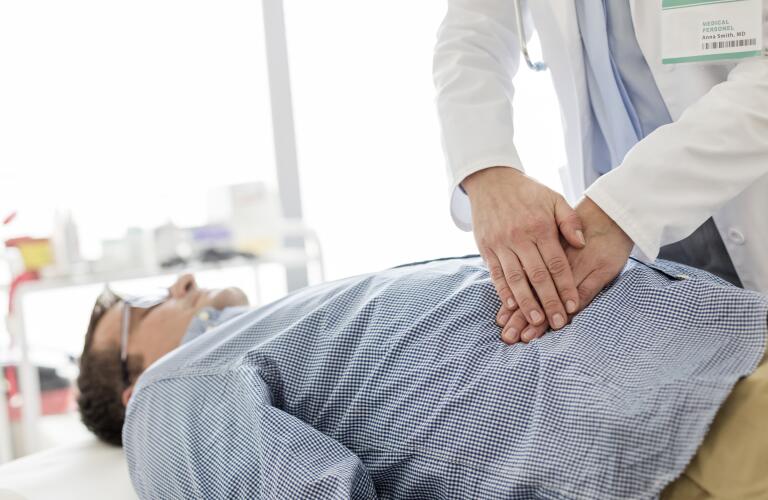 doctor examining patient's stomach