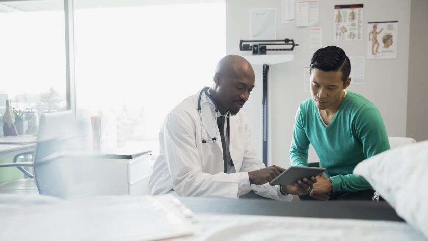 doctor looking at results with patient