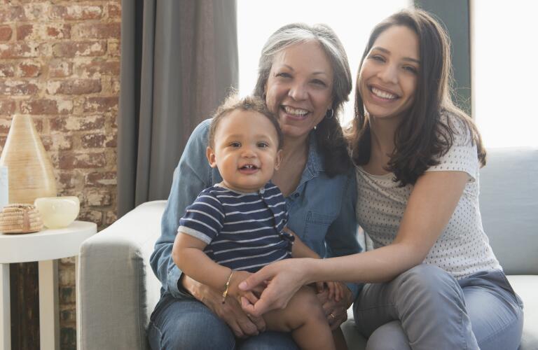 portrait of smiling grandmother with daughter and grandchild