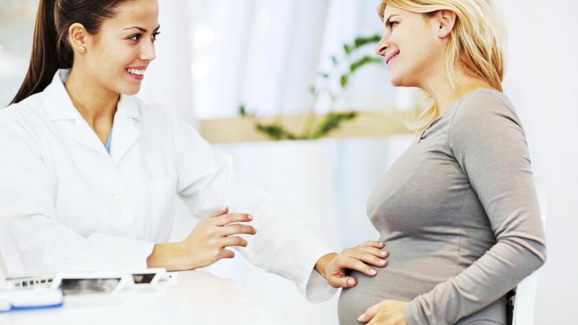 Female doctor talking to a pregnant woman